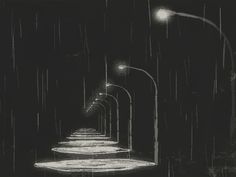 an artistic black and white photo of a walkway in the rain at night with street lights