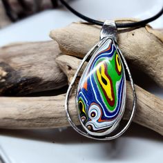 This Has So Many Bright Colors! This Fordite Came From The Kenworth Truck Factory. Normally I Form And Polish All Of My Fordite, But This Is The First One That I Purchased From A Seller. I Created The Sterling Silver Setting And Gave It A Darker Finish To Soften The Look Of The Silver. It Comes With A 20 Inch Leather Cord Necklace With A Sterling Silver Clasp. I Also Added A Picture Of What Fordite Looks Like When I Purchase It. What Is Fordite? It's Overspray From Painting The Trucks. When The Leather Cord Necklace, Kenworth Trucks, Leather Corded Necklace, Cord Necklace, Leather Cord, Bright Colors, Necklace Set, Silver Color, Trucks