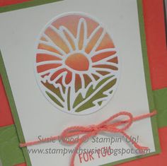 a close up of a card with a flower on the front and an orange background