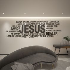 a living room with a couch and table in front of a wall that has words on it