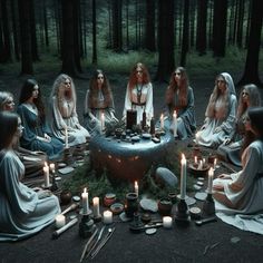 a group of women sitting around a table with candles