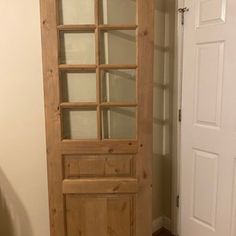 a wooden door with glass panels in a room