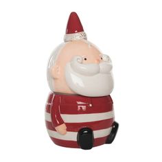 a santa clause figurine with a red and white striped shirt on it's chest