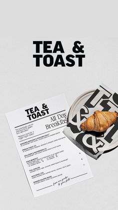 an advertisement for tea and toast with a croissant on a plate next to a piece of paper