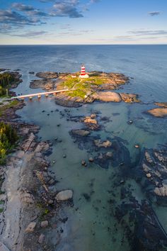 an aerial view of a lighthouse in the ocean