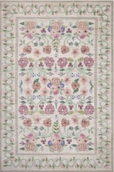 a white rug with pink flowers and green leaves on the bottom, in front of a light blue background