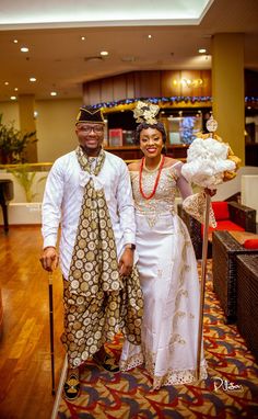 a man and woman dressed in african attire