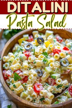 pasta salad in a wooden bowl with a spoon