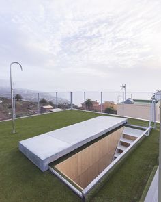 a concrete bench sitting on top of a lush green field