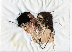 an embroidered piece of cloth with two women's faces on it