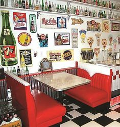 a checkered floor in a restaurant with red booths and white walls filled with beer bottles