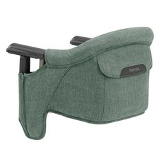 the reclining chair is green and has black straps on its arm, while it sits in