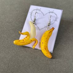 Banana earrings:  Handmade with clay and hand-painted. 💛 Please know that because they are made to order, all the new ones will not look exactly the same from the pictures. Also there will always be some finger prints visible as shown in pictures as I hand make everything, they may not be too obvious but if you look into it, it can be seen, although I think they make the jewelleries cooler. 😎 It normally takes me 1-7 days to make things depends on how many orders I have. If you love my art, tag us @itsflorences on Instagram with your picture. I'd love to see you guys in my designs.  Love,  Florence Banana Earrings, Crazy Earrings, Banana Fruit, Quirky Jewelry, Quirky Earrings, Fruit Earrings, Funky Jewelry, Polymer Clay Crafts, Fun Earrings