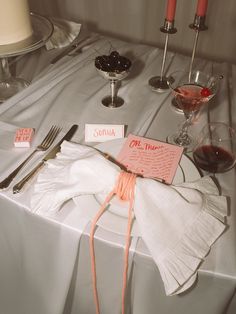 the table is set with silverware and napkins for guests to use as place cards