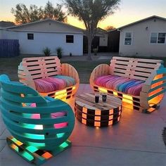 outdoor furniture made out of pallet wood and colored lights