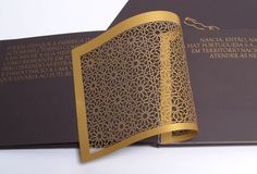 an open book with gold foil on it