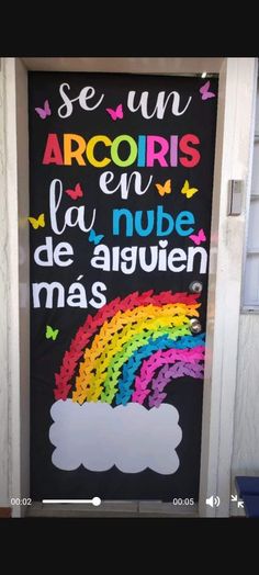 a door decorated with an image of a rainbow and the words acoriss en la nube de arguien mas