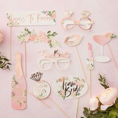 wedding photo props and flowers on a pink background