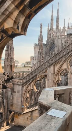 the view from inside an old building looking down on cathedrals and spires in europe