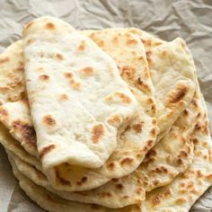 a stack of flat breads sitting on top of a piece of paper