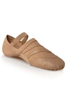 a woman's tan leather ballet shoe with straps on the front and back side