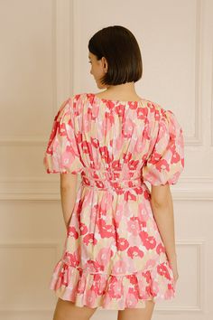 Step into your next special occasion in style with the Julia Pink Floral Mini Dress. This chic and vibrant dress is perfect for spring and summer events, featuring a flirty mini design with a multi-tonal pink floral print. It also has a deep V-neckline, short puffy sleeves, an empire-gathered cinched waist, and a ruffled hem. Show off your stylish look and feel confident in this timeless dress. Composition:Cotton Pink Floral Print V-neck Mini Dress, Pink V-neck Mini Dress For Spring, Pink Floral V-neck Dress For Brunch, Pink Mini Floral Print Dress, Pink Floral Print Mini Length Dress, Pink Mini Length Floral Dress, Pink Floral Mini Dress For Garden Party, Spring Pink Floral Print Mini Dress, Pink Floral Print Mini Dress For Spring