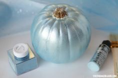 a blue pumpkin sitting on top of a table next to some glue and other items