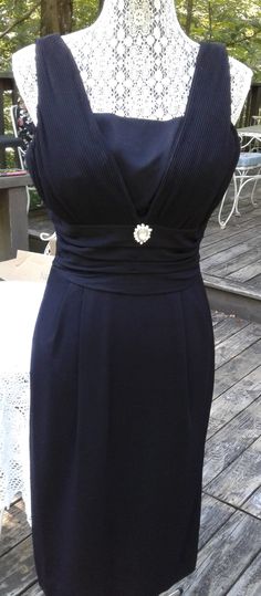 "This is the ultimate little black dress.  1950s/60s. Fully lined, pleated bust, shirred waist, pleats at front of skirt and pleat at hem in back to help when walking. Waist embellished with faux rhinestone brooch. MEASUREMENTS (LAYING FLAT) Bust - 18\" Waist - 15-1/2\" Hips - 20\" Shoulder to hem - 43\"" Black Dress 1950s, Black Wiggle Dress, Wiggle Dress, Dress Clothes For Women, Going Out, Little Black Dress, Dress Outfits, Black Dress, Womens Dresses