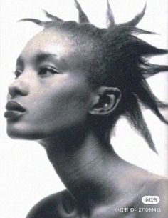 a black and white photo of a woman with mohawks