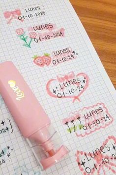 a pink pen sitting on top of a piece of paper with some writing on it