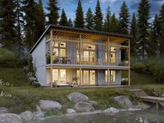 a house built into the side of a hill next to a body of water at night