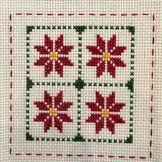 a cross stitch pattern with poinsettis on it