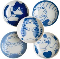 four blue and white plates with cats on them