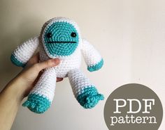 a hand holding a crocheted stuffed animal in front of a white wall with the words pdf pattern below it