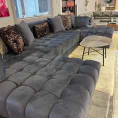 a large gray couch with lots of pillows on it