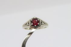 Vintage Sterling Silver Ruby Carved Filigree Ring....Marked 925...Total of weights 3.0grams... Size 7...Measure of Face 8.9MM...It's in very good condition. Classic Engraved Round Ruby Ring, Sterling Silver Ruby Ring With Diamond Cut, Classic Engraved Ruby Ring, Classic Sterling Silver Birthstone Ring Stamped 925, Classic Silver Engraved Birthstone Ring, Classic Sterling Silver Ruby Ring For Anniversary, Classic Silver Ruby Ring For Anniversary, Classic Engraved Silver Birthstone Ring, Classic Birthstone Promise Ring Stamped 925