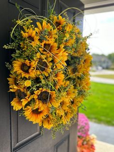 a sunflower wreath hangs on the front door