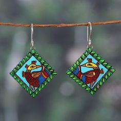 Imitating the luxurious Kalamkari art style, a pair of majestic peacocks decorate Ritu Thapar's homage to India. Local artisans craft these diamond-shaped dangle earrings from ceramic, painting them by hand with a classic regional style that combines vibrant hues in one luxurious composition. As the final touch, sterling silver hooks allow for comfortable wear. Kalamkari Peacock, Kalamkari Art, Diy Jewlery, India Gift, Gift Suggestions, Peacock Green, Green Ceramics, Final Touch, Diamond Shaped