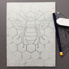 a drawing of a bee on top of a piece of paper next to a ruler