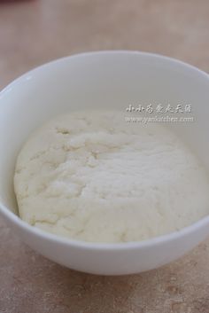 a white bowl filled with food on top of a table