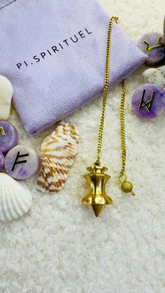 the contents of a purse are laid out on the floor next to shells and seashells