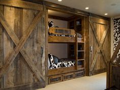 a wooden bunk bed sitting inside of a bedroom next to a closet with sliding doors