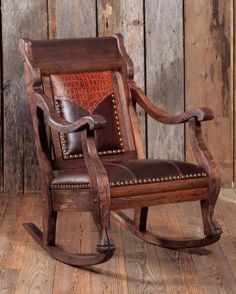 a wooden rocking chair with brown leather seats