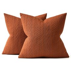 two brown pillows sitting on top of each other