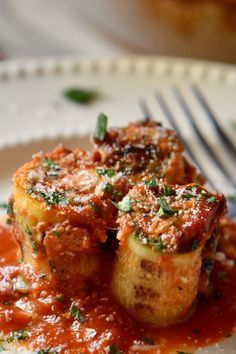 a white plate topped with meat covered in sauce