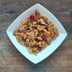 a white plate topped with granola and nuts