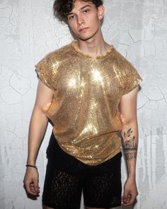 Elevate your fashion game with our Men's Gold Sequin Shirt. This stunning piece is designed to make you shine on any occasion. Whether it's a special event or a night out, this shirt will turn heads and leave a lasting impression. Its high-quality sequin fabric is comfortable and eye-catching, ensuring you stand out from the crowd. Available in various sizes to suit your fit. Order yours now and be the center of attention! Shiny Outfits Men, Gold Party Outfit Men, Mens Gold Outfit, Black And Gold Male Outfits, Mens Sparkle Outfit, Reputation Era Outfits Men, Golden Outfit Men, Sun Outfits Men, Sequin Short Sleeve Party T-shirt