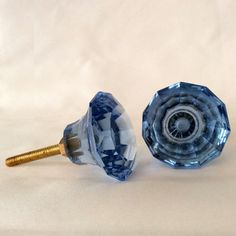 two blue glass knobs sitting next to each other