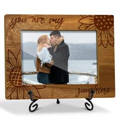 a wooden frame with an image of two people kissing and the words you are my sunshine on it