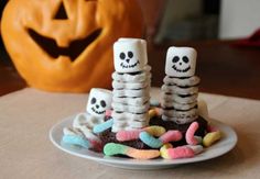 halloween treats on a plate in front of a pumpkin